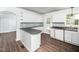 Well-lit kitchen with white cabinets, stainless steel appliances, and stylish backsplash at 4605 Malor Dr, Wake Forest, NC 27587