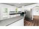 Bright kitchen with stainless steel appliances, white cabinets, and hardwood floors at 4605 Malor Dr, Wake Forest, NC 27587