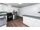 Functional kitchen featuring white cabinets, stainless steel appliances, and dark countertops at 4605 Malor Dr, Wake Forest, NC 27587