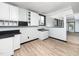 A kitchenette with white cabinets, a sink, and open access to a dining area at 4605 Malor Dr, Wake Forest, NC 27587