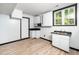 Functional kitchenette with white cabinets, black countertop, and a bright window at 4605 Malor Dr, Wake Forest, NC 27587