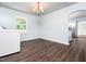 Laundry area with modern appliances, hardwood floors and an arched doorway to the kitchen at 4605 Malor Dr, Wake Forest, NC 27587