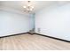 Open living room with sleek floors, chandelier, and staircase access at 4605 Malor Dr, Wake Forest, NC 27587