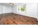 Bright living room featuring hardwood floors, large bay window, and a ceiling fan at 4605 Malor Dr, Wake Forest, NC 27587