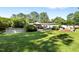 Expansive backyard with a pool, outdoor seating, and mature trees, perfect for relaxing at 4701 Governor Hunt St, Efland, NC 27243
