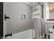 Contemporary bathroom featuring gray tiled walls, a bathtub with a glass screen, and a convenient shower niche at 4701 Governor Hunt St, Efland, NC 27243