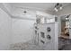 Luxurious walk-in shower boasts white marble tiles with a mosaic accent and stone floor at 4701 Governor Hunt St, Efland, NC 27243