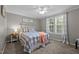 Cozy bedroom with plush carpet, inviting natural light from two windows, and a decorative ceiling fan at 4701 Governor Hunt St, Efland, NC 27243