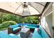 Stylish covered deck featuring cozy seating around a modern fire pit, perfect for outdoor living at 4701 Governor Hunt St, Efland, NC 27243