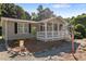 Front exterior view of a inviting ranch home with a cozy front porch and fresh landscape at 4701 Governor Hunt St, Efland, NC 27243