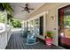 View of the front porch, featuring blue rocking chairs and ceiling fan at 4701 Governor Hunt St, Efland, NC 27243