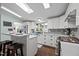 Well-lit kitchen with white cabinets, gray backsplash, stainless appliances, and a skylight at 4701 Governor Hunt St, Efland, NC 27243