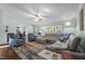 Open-concept living room with a comfortable gray sectional couch and large patterned rug at 4701 Governor Hunt St, Efland, NC 27243