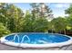 Inviting above-ground pool with surrounding deck space perfect for summer fun at 4701 Governor Hunt St, Efland, NC 27243