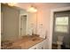 Bathroom featuring a dual sink vanity, large mirror, and separate toilet area at 474 Ashpole Trl, Clayton, NC 27520