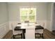 Charming dining room with a modern black and white table set under a decorative light fixture at 474 Ashpole Trl, Clayton, NC 27520