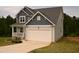 Charming two-story home with attached garage and well-manicured lawn at 474 Ashpole Trl, Clayton, NC 27520