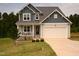 Inviting two-story home with a welcoming front porch and attached garage at 474 Ashpole Trl, Clayton, NC 27520