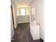 Light-filled upstairs hallway featuring neutral walls, grey carpet, and a small storage shelf at 474 Ashpole Trl, Clayton, NC 27520