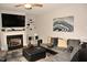 Comfortable living room with a fireplace, TV, area rug and decorative wall art at 474 Ashpole Trl, Clayton, NC 27520