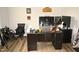 Spacious office with a dark wood desk, multiple monitors, and comfortable seating at 474 Ashpole Trl, Clayton, NC 27520