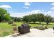 Spacious backyard with well-manicured lawn, a charming fire pit, and pond view at 509 Spruce Meadows Ln, Willow Springs, NC 27592