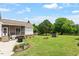 Expansive backyard featuring a fire pit, patio, and a picturesque pond view at 509 Spruce Meadows Ln, Willow Springs, NC 27592