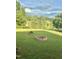 Scenic backyard with a fire pit and a tranquil lake at 509 Spruce Meadows Ln, Willow Springs, NC 27592