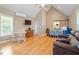 Spacious bedroom with vaulted ceiling, TV, barn door to the bathroom and hardwood flooring at 509 Spruce Meadows Ln, Willow Springs, NC 27592