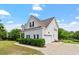 Classic two-story home with attached garage, complemented by lush landscaping at 509 Spruce Meadows Ln, Willow Springs, NC 27592