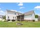 Spacious backyard featuring a fire pit, patio, and a picturesque view of the rear elevation at 509 Spruce Meadows Ln, Willow Springs, NC 27592