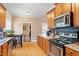 Bright kitchen features granite countertops, stainless steel appliances, wood floors and cabinetry at 509 Spruce Meadows Ln, Willow Springs, NC 27592