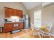 Kitchenette features stainless steel refrigerator, granite counter and wooden cabinets at 509 Spruce Meadows Ln, Willow Springs, NC 27592