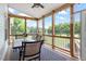 Inviting screened porch with picturesque views of the backyard pond at 509 Spruce Meadows Ln, Willow Springs, NC 27592