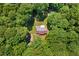 Aerial view of a cozy home surrounded by lush trees with a private drive and spacious yard at 560 Parker Creek Rd, Holly Springs, NC 27540