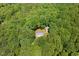 Overhead view of house surrounded by dense forest, showcasing a secluded, private setting at 560 Parker Creek Rd, Holly Springs, NC 27540