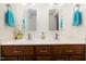 Bathroom featuring double sinks, wood cabinets, vanity lighting and white marble countertops at 560 Parker Creek Rd, Holly Springs, NC 27540
