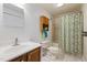 Cozy bathroom with a vanity, toilet, and shower featuring a decorative shower curtain at 560 Parker Creek Rd, Holly Springs, NC 27540