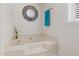 Relaxing bathroom featuring a large soaking tub with a decorative mirror and towel rack at 560 Parker Creek Rd, Holly Springs, NC 27540
