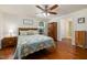 Comfortable bedroom with ceiling fan, wood floors, and a window for ample natural light at 560 Parker Creek Rd, Holly Springs, NC 27540