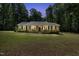 Charming one-story home with a metal roof, front porch, and well-lit exterior at 560 Parker Creek Rd, Holly Springs, NC 27540