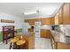 Spacious kitchen boasts oak cabinets, white appliances, a granite island, and a breakfast bar at 560 Parker Creek Rd, Holly Springs, NC 27540