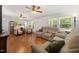 Bright living room with hardwood floors, ceiling fans, and comfortable seating arrangements at 560 Parker Creek Rd, Holly Springs, NC 27540
