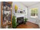 Inviting living room with a cozy fireplace and natural light from the window at 560 Parker Creek Rd, Holly Springs, NC 27540