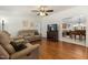 Cozy living room with wood floors, neutral furniture, and an open doorway to a dining area at 560 Parker Creek Rd, Holly Springs, NC 27540