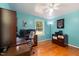 Bright and efficient home office space with hardwood floors and a ceiling fan at 560 Parker Creek Rd, Holly Springs, NC 27540