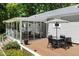 Back porch with outdoor dining set and sunroom access, great for entertaining at 560 Parker Creek Rd, Holly Springs, NC 27540