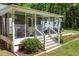 Cozy screened-in porch with wicker furniture, ideal for relaxing outdoors at 560 Parker Creek Rd, Holly Springs, NC 27540