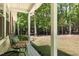 Relaxing covered porch with seating, offering a peaceful view of the surrounding wooded landscape at 560 Parker Creek Rd, Holly Springs, NC 27540