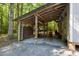 Backyard shed with gravel floor and covered lean-to attached at 560 Parker Creek Rd, Holly Springs, NC 27540